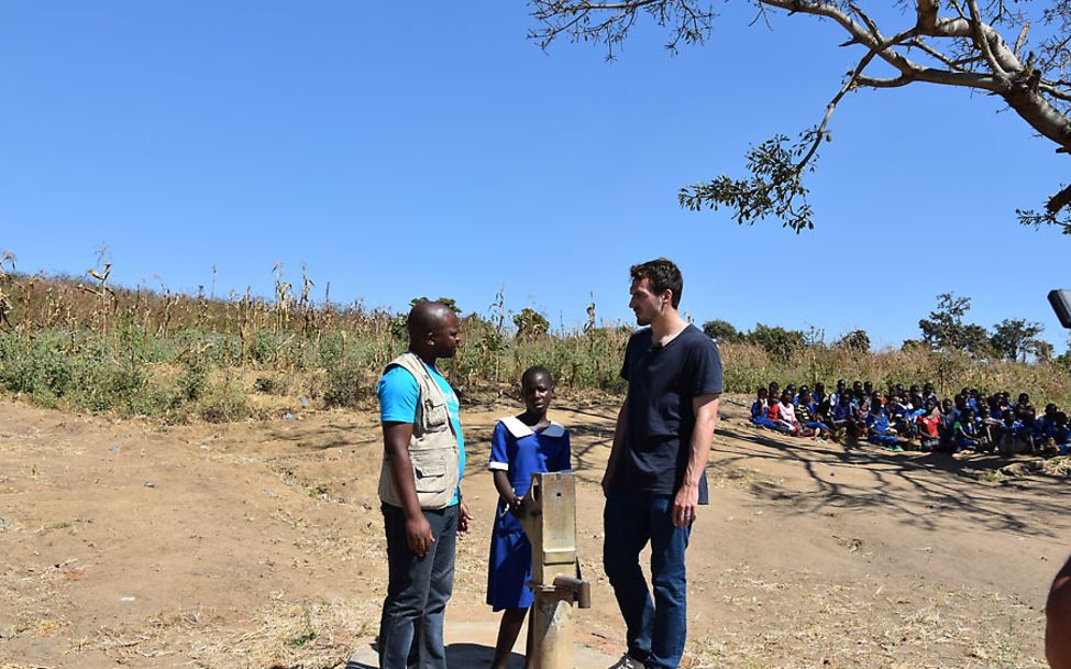 Mats Hummels hört aufmerksam den Schilderungen eines UNICEF-Mitarbeiters zu.