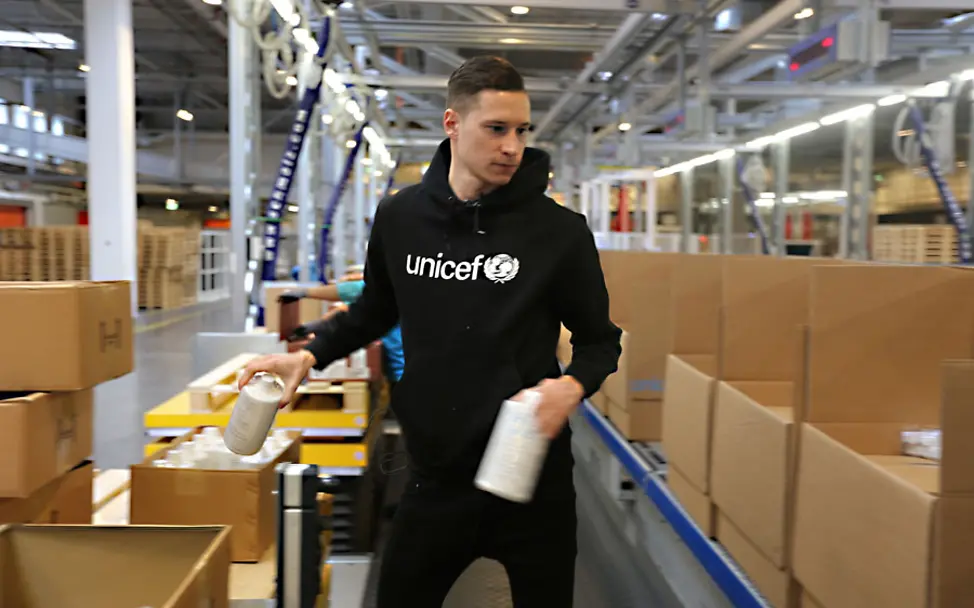 Julian Draxler packt UNICEF-Hilfspakete in Kopenhagen | © Thomas Ulrich/UNICEF Julian Draxler packt UNICEF-Hilfspakete in Kopenhagen.