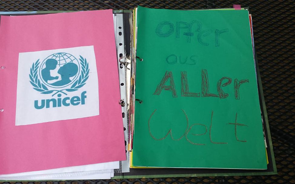 Eine Ordnerseite: Opfer aus aller Welt und das UNICEF-Logo