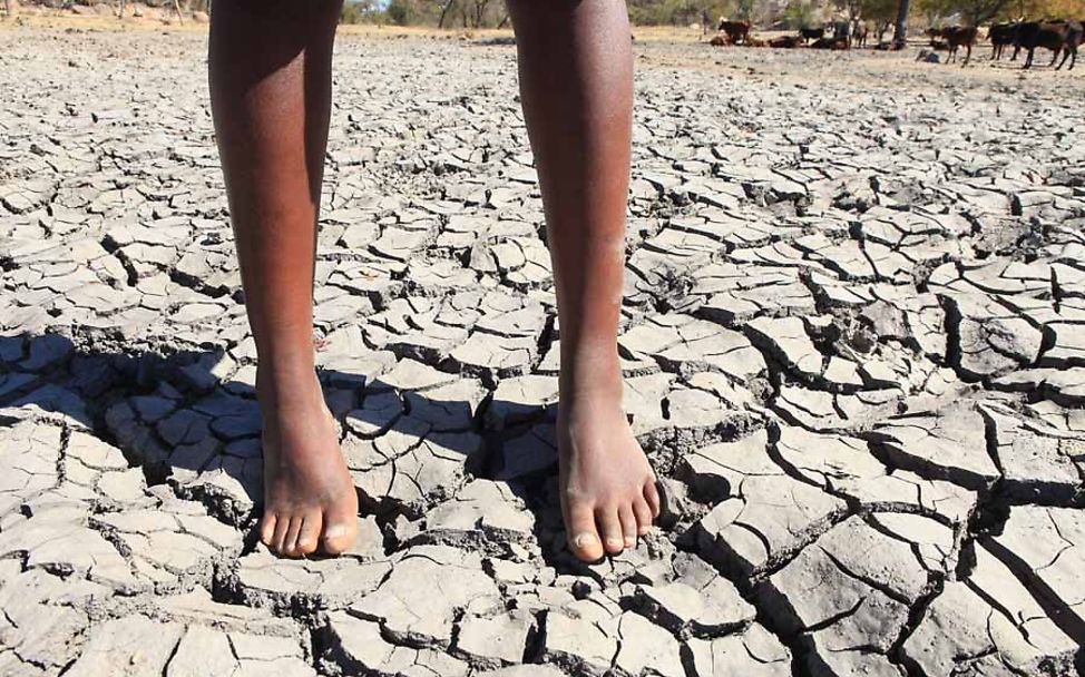 Zimbabwe: Ein Kind steht in einem ausgetrockneten Flussbecken.