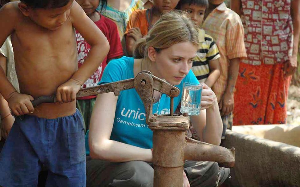 Kambodscha: Eva Padberg trinkt Wasser aus einer Filteranlage (© UNICEF Deutschland/Claudia Berger)