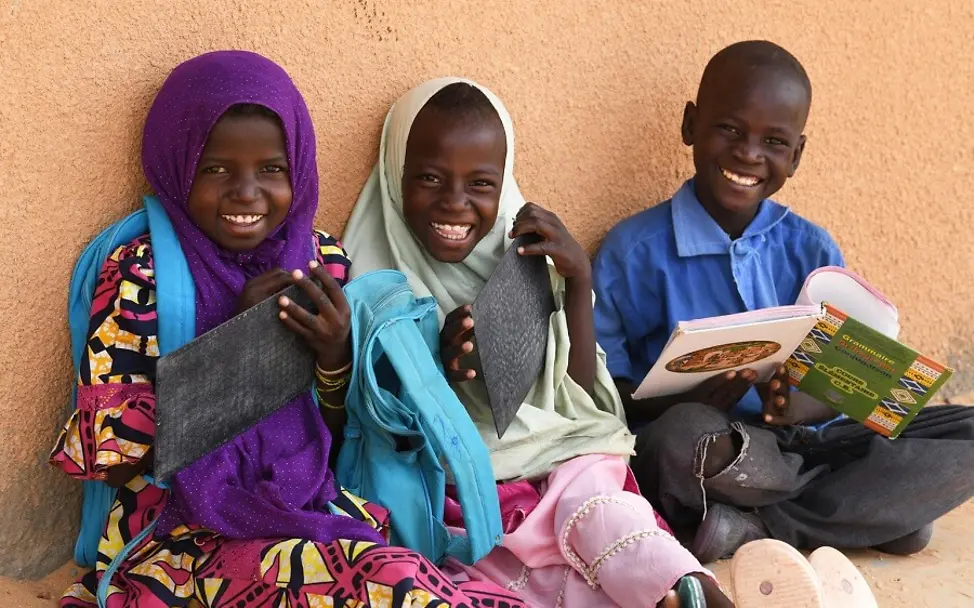 In Niger ist das Bildungsniveau für Kinder sehr niedrig. | © UNICEF/Frank Dejongh Nigeria: Schüler sitzen mit Lernsachen auf dem Boden.