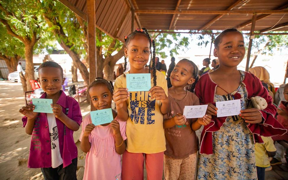 Kinder im Sudan halten nach einer Impfung ihre Impfausweise hoch. 