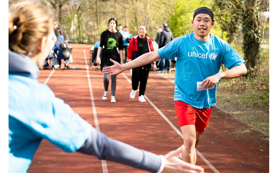 A student is high-fived while running.