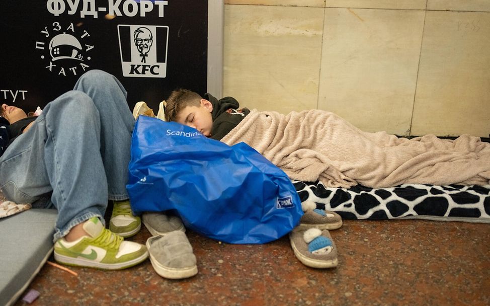 Ukraine: Junge schläft in Metrostation, wo er vor den Angriffen Schutz sucht.