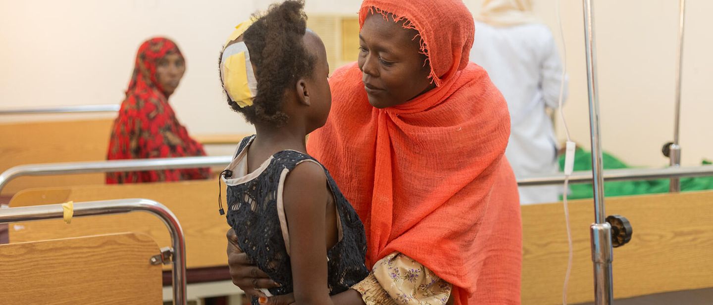 A mother hugs her daughter in hospital in Sudan 