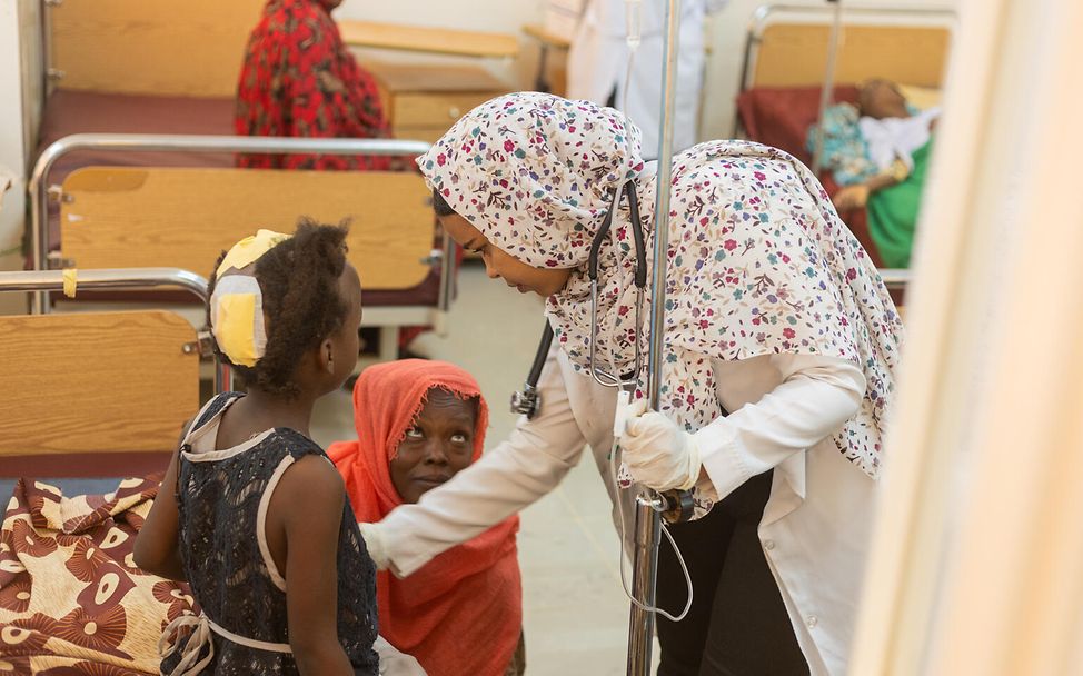 A doctor caring for a child in an hospital in Sudan