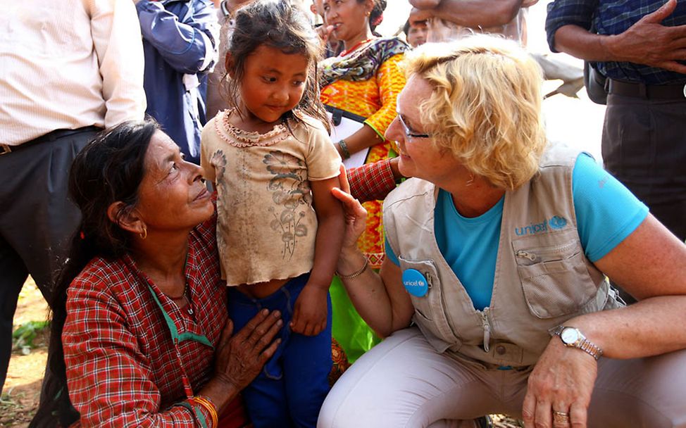 Nepal Erdbeben: UNICEF-Mitarbeiterin mit einer betroffenen Familie 