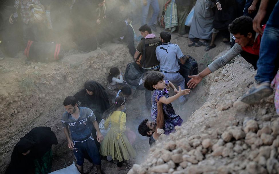 Grenze Syrien/Türkei: Flucht durch den Stacheldraht | © Bülent Kiliç/AFP