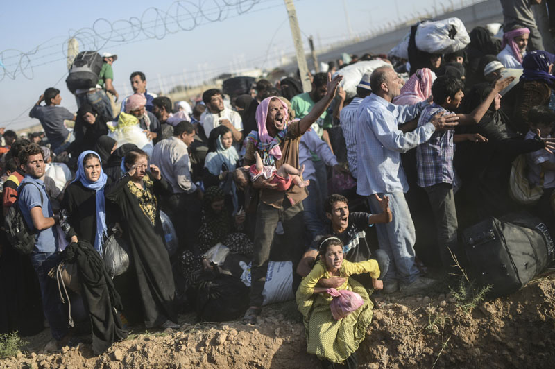 Grenze Syrien/Türkei: Flucht durch den Stacheldraht | © Bülent Kiliç/AFP